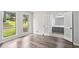 Inviting bedroom features wood-look flooring, neutral walls, and a view of the front yard at 6249 Townsend Way, Riverdale, GA 30296