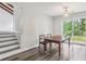 Bright dining space with a modern light fixture, sliding door to the backyard, and easy access to the kitchen at 6249 Townsend Way, Riverdale, GA 30296