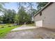 Paved driveway leading to a two-car garage surrounded by lush greenery at 6249 Townsend Way, Riverdale, GA 30296