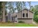 Charming two-story home with neutral siding, manicured lawn, and inviting curb appeal in a lush, wooded setting at 6249 Townsend Way, Riverdale, GA 30296