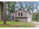 Charming home exterior with a two-car garage, lush front yard, and mature trees at 6249 Townsend Way, Riverdale, GA 30296