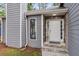 Close-up of a charming front entrance with stone accents, a welcoming door, and neat landscaping features at 6249 Townsend Way, Riverdale, GA 30296