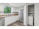 Updated kitchen features stainless steel refrigerator, modern cabinetry, and plenty of natural light at 6249 Townsend Way, Riverdale, GA 30296