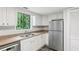 Functional kitchen features white cabinets, modern stainless steel appliances, and laminate countertops at 6249 Townsend Way, Riverdale, GA 30296