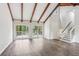 Spacious living area showcasing vaulted ceilings with wood beams and large glass doors leading to an outdoor deck at 6249 Townsend Way, Riverdale, GA 30296