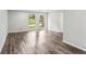 Spacious living room with gleaming hardwood floors, neutral paint, and double windows at 6249 Townsend Way, Riverdale, GA 30296