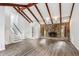 Inviting living room features stone fireplace, vaulted ceilings, modern flooring, and staircase to the upper level at 6249 Townsend Way, Riverdale, GA 30296