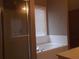 Bathroom featuring a separate shower and tub, with neutral tile and light-colored walls at 1378 Lucile Sw Ave, Atlanta, GA 30310