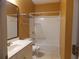 A standard bathroom with a shower/tub combo, white tile, yellow walls, and a single sink vanity at 1378 Lucile Sw Ave, Atlanta, GA 30310