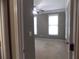 A look into the neutral carpeted bedroom with two bright windows, a ceiling fan, and neutral-colored walls at 1378 Lucile Sw Ave, Atlanta, GA 30310