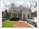 Charming home with a welcoming front porch, American flag, and a silver car parked in the driveway at 1378 Lucile Sw Ave, Atlanta, GA 30310