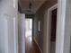 Hallway with hardwood floors, leading to rooms with neutral carpet and a bathroom on the right at 1378 Lucile Sw Ave, Atlanta, GA 30310