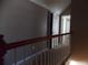 Upstairs hallway with white railing and neutral walls leads to rooms, showcasing layout at 1378 Lucile Sw Ave, Atlanta, GA 30310