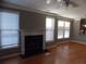 Spacious living room featuring gleaming hardwood floors, a classic fireplace, and lots of natural light at 1378 Lucile Sw Ave, Atlanta, GA 30310