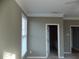 View of the primary bedroom showing an en-suite bathroom, neutral carpet, and gray walls at 1378 Lucile Sw Ave, Atlanta, GA 30310