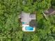 Home with a private pool surrounded by lush greenery and mature trees, offering a serene retreat at 215 Ansley Ct, Roswell, GA 30076