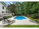 Poolside view with lawn chairs, patio area, fence, and a deck for relaxing and entertaining at 215 Ansley Ct, Roswell, GA 30076