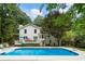 An inviting backyard oasis features a large swimming pool with deck, and a well-maintained lawn for outdoor enjoyment at 215 Ansley Ct, Roswell, GA 30076