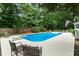 Large private backyard features a diving board, lounge chairs, an inground pool, and privacy fence at 215 Ansley Ct, Roswell, GA 30076