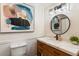 Modern bathroom featuring stylish vanity with marble countertop, round mirror, and modern fixtures at 215 Ansley Ct, Roswell, GA 30076