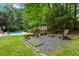 Cozy backyard firepit area with Adirondack chairs, ideal for enjoying evenings outdoors at 215 Ansley Ct, Roswell, GA 30076