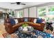 Bright living room with hardwood floors and a comfortable sectional sofa at 215 Ansley Ct, Roswell, GA 30076