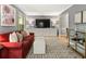 Spacious living room with modern decor, a large television, and a comfortable seating area for relaxation and entertainment at 215 Ansley Ct, Roswell, GA 30076