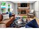 Spacious living room features a brick fireplace, ceiling fan, and ample seating at 215 Ansley Ct, Roswell, GA 30076