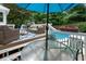 Entertaining pool deck with dining set, grill, comfortable seating, and lush greenery at 215 Ansley Ct, Roswell, GA 30076
