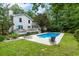 Inviting in-ground pool with surrounding patio and lush green backyard, perfect for outdoor relaxation and entertainment at 215 Ansley Ct, Roswell, GA 30076