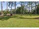 Expansive backyard featuring a storage shed and mature trees providing shade at 3220 Casteel Rd, Marietta, GA 30062
