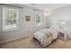 Comfortable bedroom with neutral color scheme, two windows and side table at 3220 Casteel Rd, Marietta, GA 30062