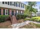 Front exterior of home featuring a brick staircase leading to a black front door and manicured landscaping at 3220 Casteel Rd, Marietta, GA 30062
