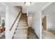 Foyer with carpeted staircase and hardwood floors leading to the upper level at 3220 Casteel Rd, Marietta, GA 30062