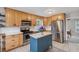 Well-equipped kitchen with stainless steel appliances, wooden cabinets, and a central island at 3220 Casteel Rd, Marietta, GA 30062