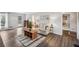 Bright living room featuring hardwood floors, a comfortable sofa, and a view of the dining room at 3220 Casteel Rd, Marietta, GA 30062