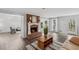 Spacious living room with a brick fireplace, hardwood floors, and large windows at 3220 Casteel Rd, Marietta, GA 30062