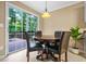 Cozy dining area features sliding door access to the outdoor deck and elegant lighting at 496 Bottesford Nw Dr, Kennesaw, GA 30144