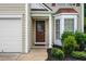 Close-up of front entrance with bay window and well-maintained landscaping at 496 Bottesford Nw Dr, Kennesaw, GA 30144