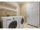 Laundry room featuring side-by-side washer and dryer and shelving at 496 Bottesford Nw Dr, Kennesaw, GA 30144