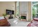 Inviting living room with fireplace, large windows, and cozy seating arrangement at 496 Bottesford Nw Dr, Kennesaw, GA 30144