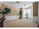 Spacious living room with carpet flooring, large windows and decorative plants at 496 Bottesford Nw Dr, Kennesaw, GA 30144