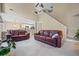 Open-concept living area with views to the kitchen and staircase, plus plush leather couches at 496 Bottesford Nw Dr, Kennesaw, GA 30144