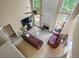 Elevated view of living room showcasing fireplace, tall windows, and comfortable sofas at 496 Bottesford Nw Dr, Kennesaw, GA 30144