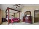 Spacious bedroom features a four-poster bed, sitting bench, and ample storage space at 496 Bottesford Nw Dr, Kennesaw, GA 30144