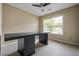Office space with window and modern workspace desk and ceiling fan at 496 Bottesford Nw Dr, Kennesaw, GA 30144