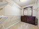Walk-in closet with extensive white wire shelving and dresser storage at 496 Bottesford Nw Dr, Kennesaw, GA 30144