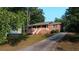 Charming brick home with a covered front porch and long driveway at 9160 Carr Cir, Covington, GA 30014