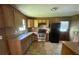 Kitchen features wood cabinets, stainless steel appliances, and a double basin sink at 9160 Carr Cir, Covington, GA 30014