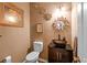 This half bath features a stylish vessel sink atop a dark wood cabinet at 2011 Wildcat Lake Ct, Lawrenceville, GA 30043